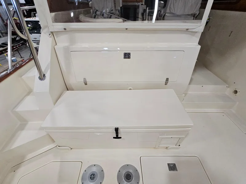 Slide: The Image of 2003 Legacy 40 Hardtop Express boat interior with storage compartments and seating area. - 17