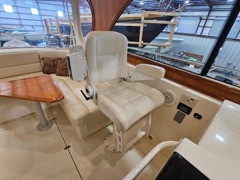 Slide: The Image of Captain's chair and seating area inside 2003 Legacy 40 Hardtop Express yacht. - 22