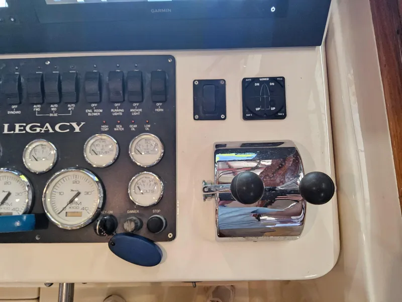 Slide: The Image of Control panel of 2003 Legacy 40 Hardtop Express with gauges and throttle levers. - 32