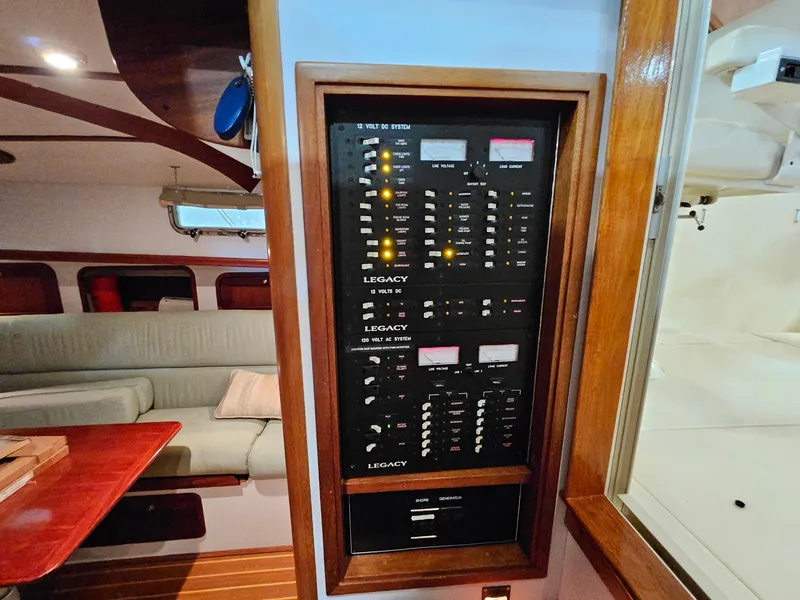 Slide: The Image of Electrical panel inside 2003 Legacy 40 Hardtop Express yacht, featuring switches and meters. - 33