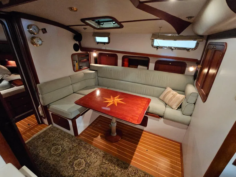 Slide: The Image of Luxurious interior of 2003 Legacy 40 Hardtop Express yacht with elegant seating and wooden table. - 38