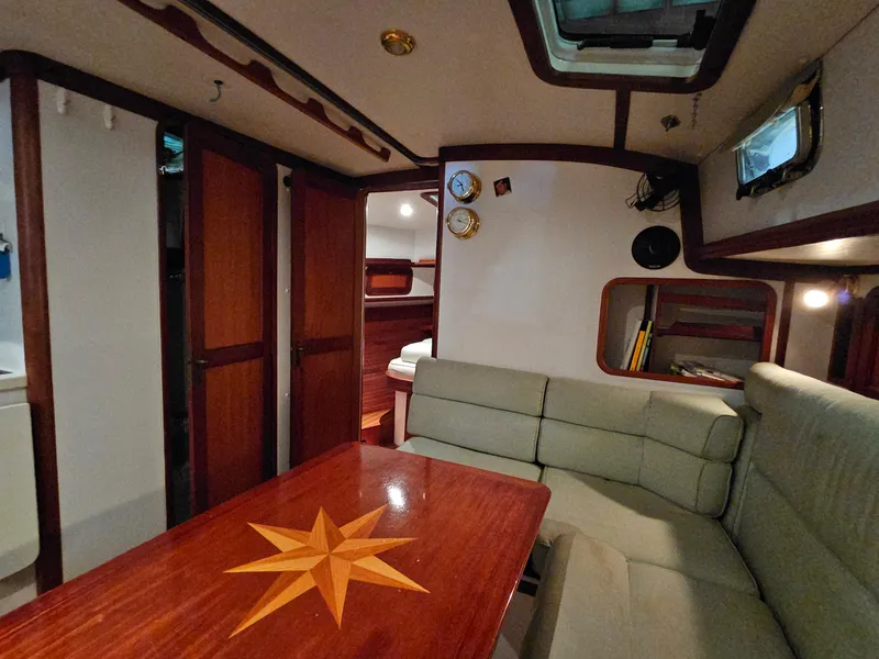 Slide: The Image of Interior of 2003 Legacy 40 Hardtop Express yacht with wooden table and cushioned seating. - 39