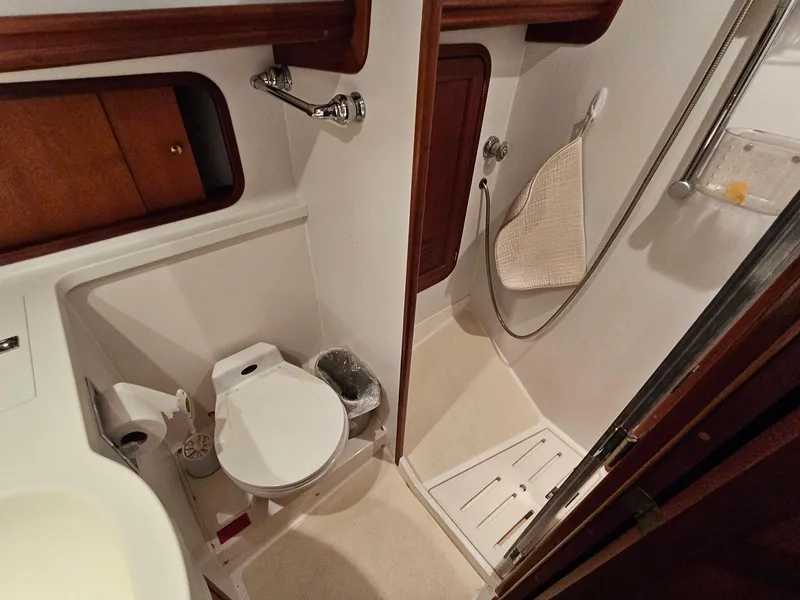 Slide: The Image of Bathroom interior of 2003 Legacy 40 Hardtop Express yacht, featuring toilet and shower. - 41