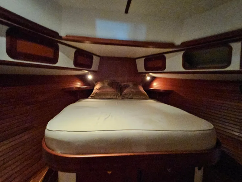 Slide: The Image of Cozy cabin interior of 2003 Legacy 40 Hardtop Express with wooden accents and comfortable bedding. - 45