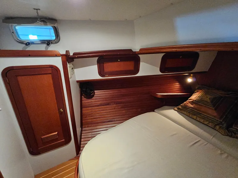 Slide: The Image of 2003 Legacy 40 Hardtop Express cabin with wood paneling and cozy bed. - 47