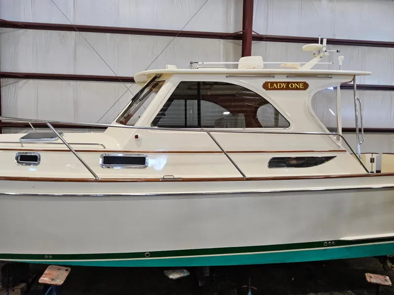 Slide: The Image of 2003 Legacy 40 Hardtop Express boat named "Lady One" in a storage facility. - 5