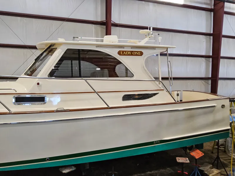 Slide: The Image of 2003 Legacy 40 Hardtop Express boat named "Lady One" in a storage facility. - 6