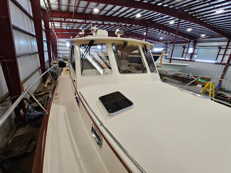 Slide: The Image of 2003 Legacy 40 Hardtop Express yacht in a spacious indoor storage facility. - 9