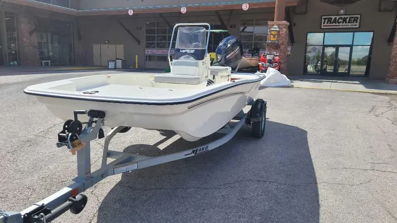 Slide: The Image of 2025 Mako Pro Skiff 15 CC boat on trailer outside dealership. - 3