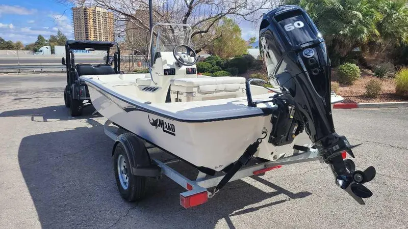 Slide: The Image of 2025 Mako Pro Skiff 15 CC boat on trailer with outboard motor. - 5