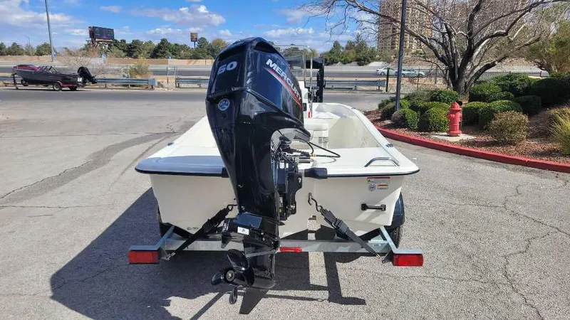 Slide: The Image of 2025 Mako Pro Skiff 15 CC with Mercury outboard motor on trailer. - 6