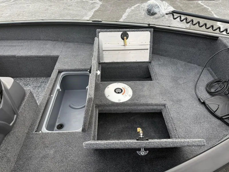Slide: The Image of 2025 Tracker Super Guide V-16 SC boat interior with storage compartments and fishing seat base. - 3