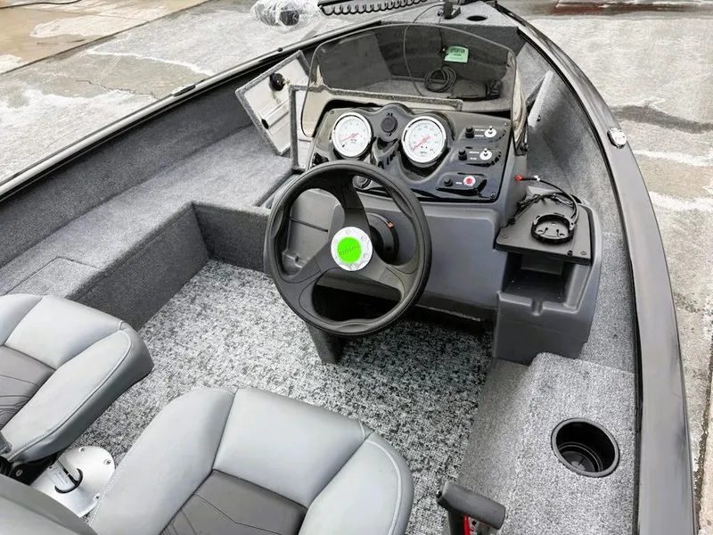 Slide: The Image of 2025 Tracker Super Guide V-16 SC boat interior with steering wheel and dashboard controls. - 5