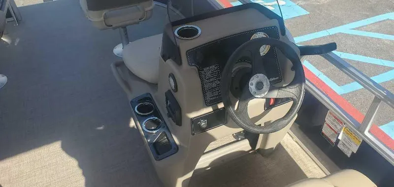 Slide: The Image of 2025 Sun Tracker Bass Buggy 16 XL Select steering console with cup holders and seating. - 4