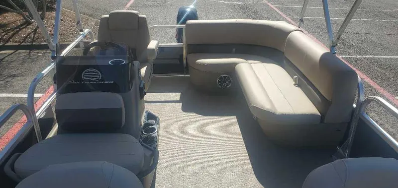 Slide: The Image of 2025 Sun Tracker Bass Buggy 16 XL Select pontoon boat interior with seating and helm. - 5