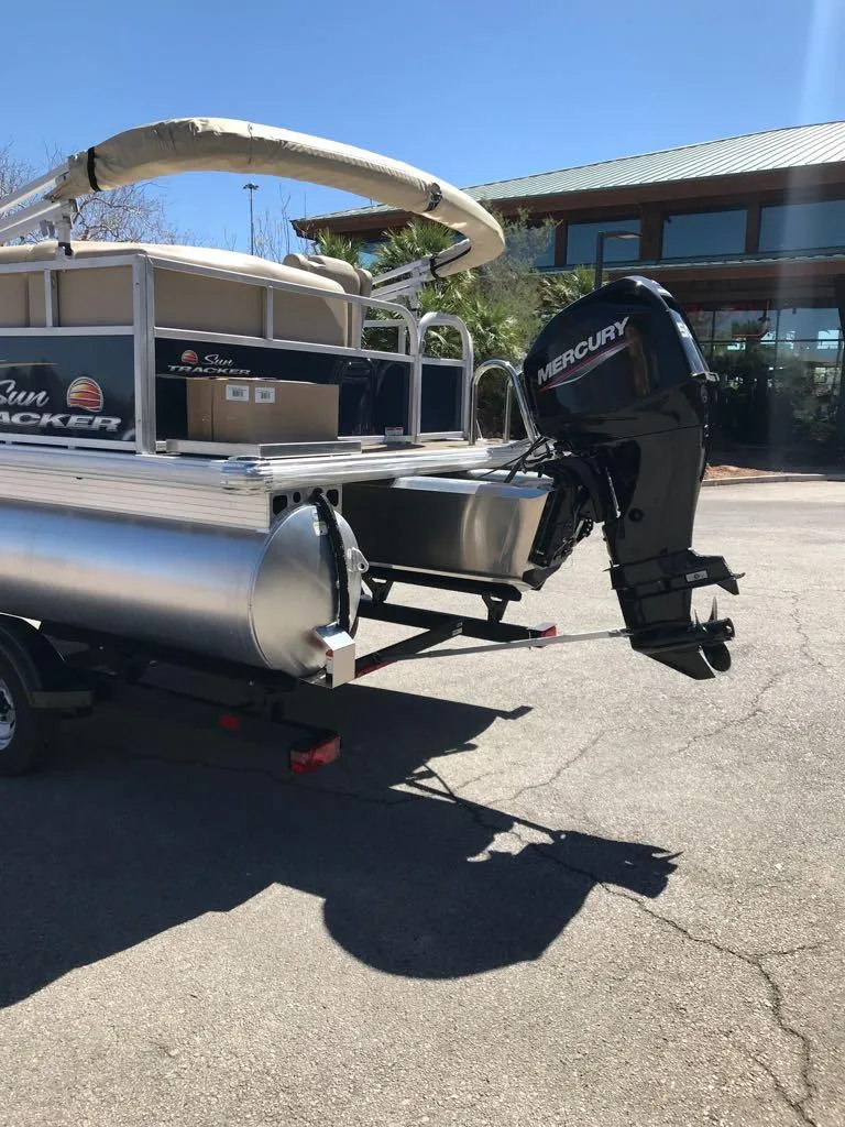 Slide: The Image of 2025 Sun Tracker Bass Buggy 16 XL Select pontoon boat with Mercury outboard motor. - 3