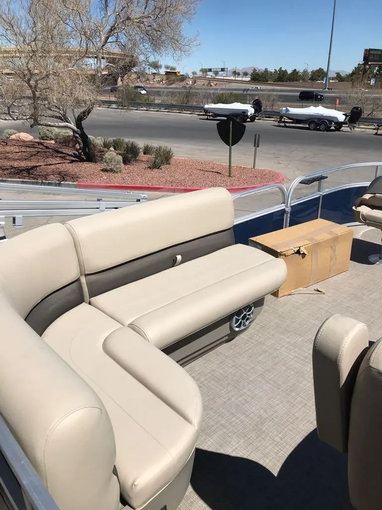 Slide: The Image of 2025 Sun Tracker Bass Buggy 16 XL Select pontoon boat with beige seating and open deck. - 6