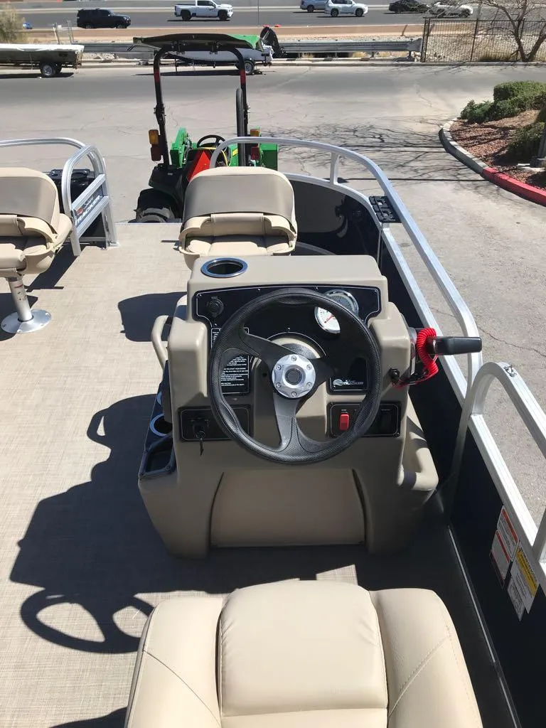 Slide: The Image of 2025 Sun Tracker Bass Buggy 16 XL Select pontoon boat interior with steering console and seating. - 7