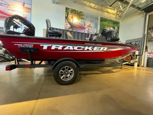 The Image of 2025 Tracker Pro Team 175 boat in showroom, red exterior, on trailer. - 0