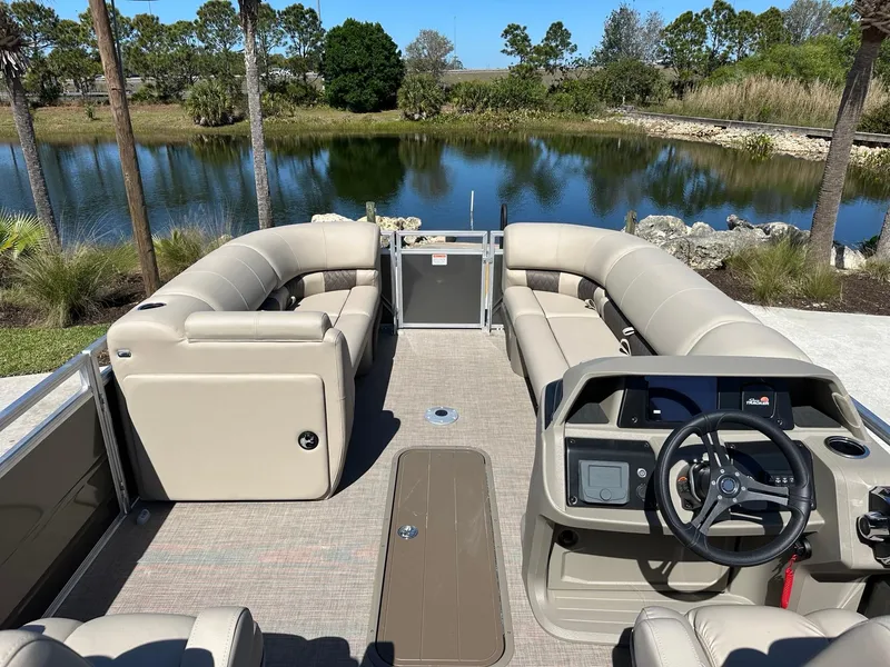 Slide: The Image of 2025 Sun Tracker Party Barge 22 XP3 pontoon boat interior with seating and steering console. - 3