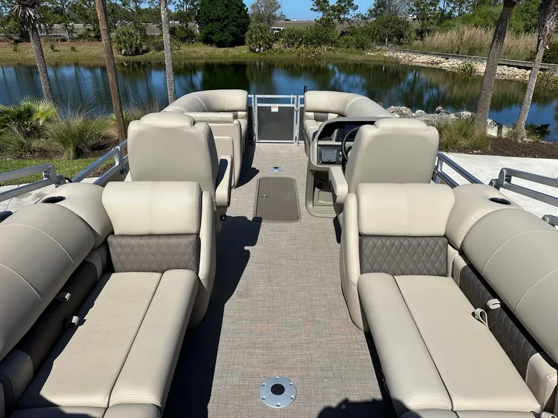 Slide: The Image of 2025 Sun Tracker Party Barge 22 XP3 pontoon boat with spacious seating and scenic lake view. - 4