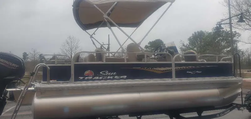 Slide: The Image of 2025 Sun Tracker Bass Buggy 18 DLX pontoon boat with canopy on a trailer. - 4