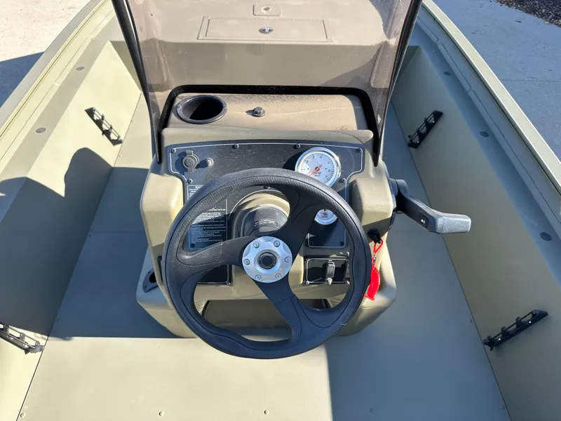 Slide: The Image of 2025 Tracker Grizzly 1860 CC boat console with steering wheel and gauges. - 5