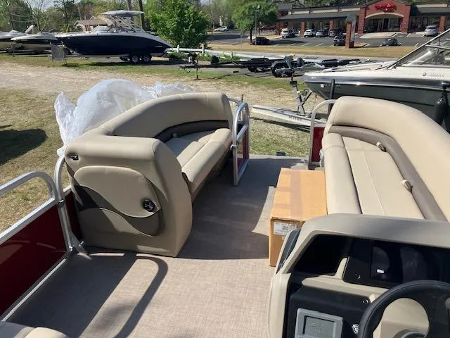 Slide: The Image of 2025 Sun Tracker Party Barge 18 DLX interior with beige seating and open deck layout. - 3