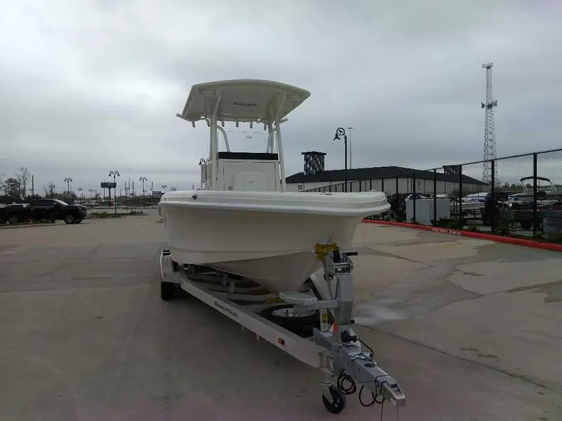 Slide: The Image of 2025 Ranger 2660 Bay boat on trailer in parking lot, overcast sky. - 2