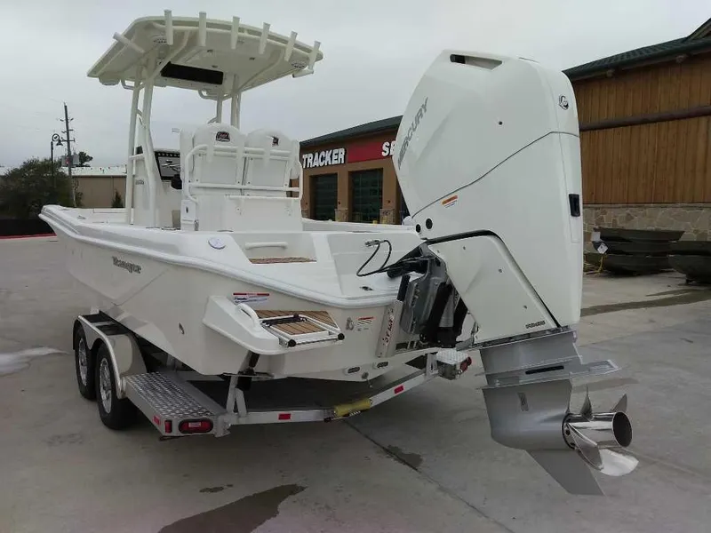 Slide: The Image of 2025 Ranger 2660 Bay boat on trailer, featuring a powerful outboard motor. - 4