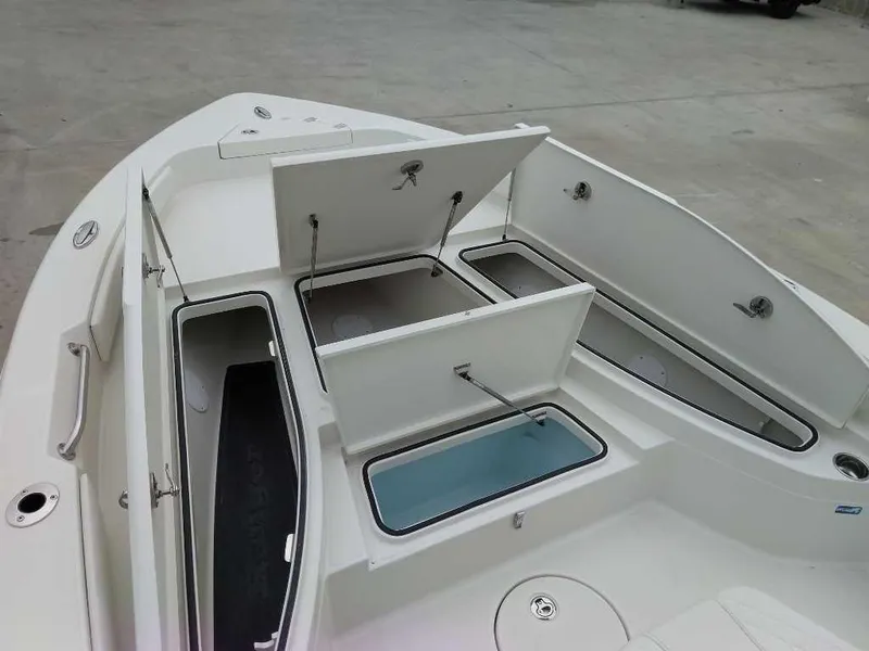 Slide: The Image of 2025 Ranger 2660 Bay boat with open storage compartments on deck. - 9