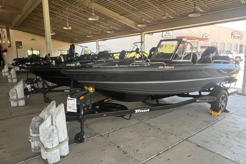 The Image of 2024 Triton 186 Allure boat displayed outside Outdoor World store. - 0