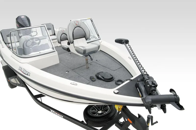 Slide: The Image of 2024 Triton 186 Allure boat on trailer, sleek design, parked indoors. - 14