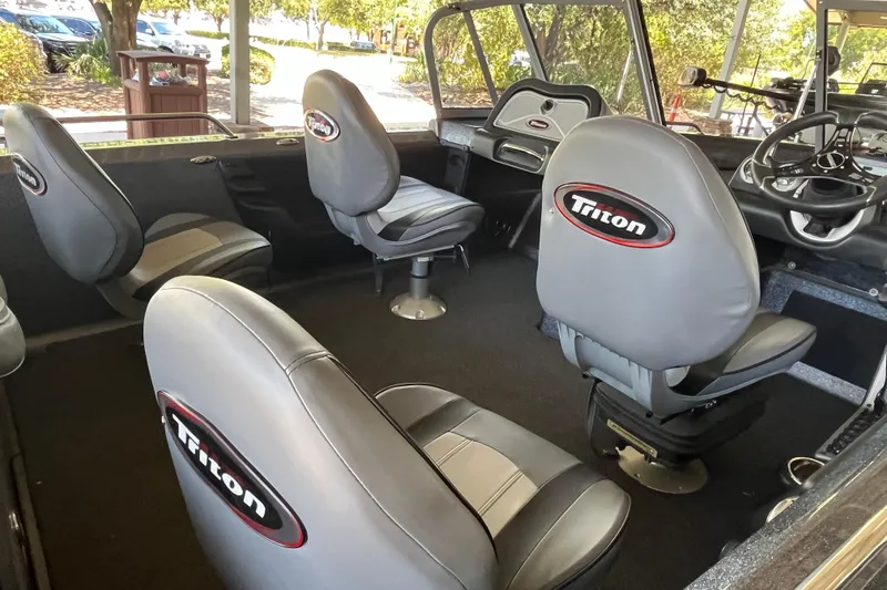 Slide: The Image of 2024 Triton 186 Allure boat interior with open storage compartment and seating. - 4
