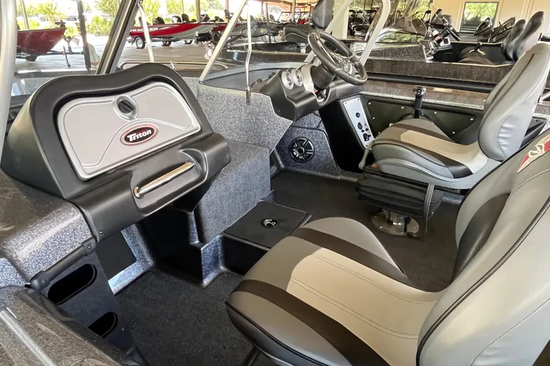 Slide: The Image of 2024 Triton 186 Allure boat interior with seating and storage compartments. - 6