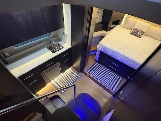 Slide: The Image of Interior of 2018 Regal 42 Grande Coupe yacht with modern kitchen and cozy bedroom. - 10