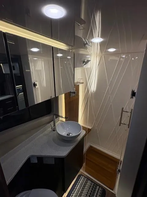 Slide: The Image of Luxurious bathroom interior of 2018 Regal 42 Grande Coupe yacht, featuring modern fixtures and lighting. - 13