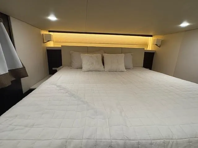 Slide: The Image of Luxurious bedroom interior of 2018 Regal 42 Grande Coupe yacht with elegant bedding. - 18