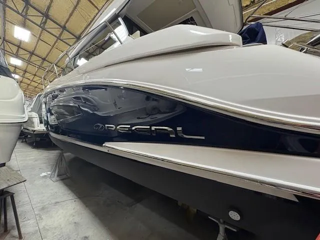 Slide: The Image of 2018 Regal 42 Grande Coupe yacht in storage, showcasing sleek design and branding. - 20