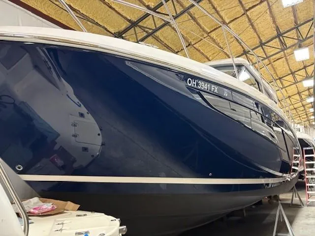 Slide: The Image of 2018 Regal 42 Grande Coupe boat in storage, blue hull, indoor facility. - 21