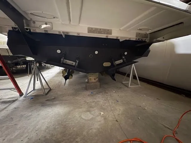 Slide: The Image of 2018 Regal 42 Grande Coupe boat hull on stands in a garage. - 22