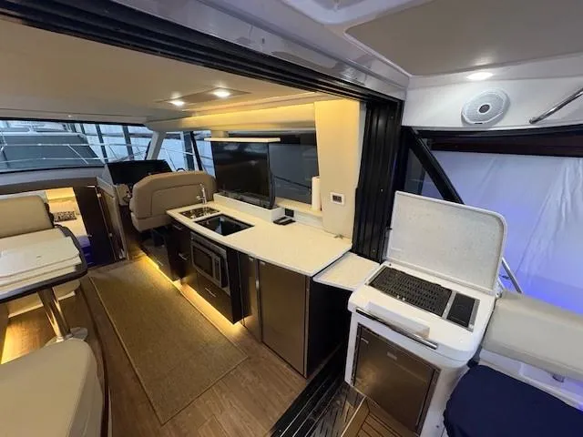 Slide: The Image of Interior of 2018 Regal 42 Grande Coupe yacht with modern kitchen and seating area. - 5