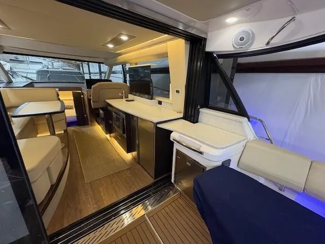 Slide: The Image of Luxurious interior of 2018 Regal 42 Grande Coupe yacht with modern seating and ambient lighting. - 8