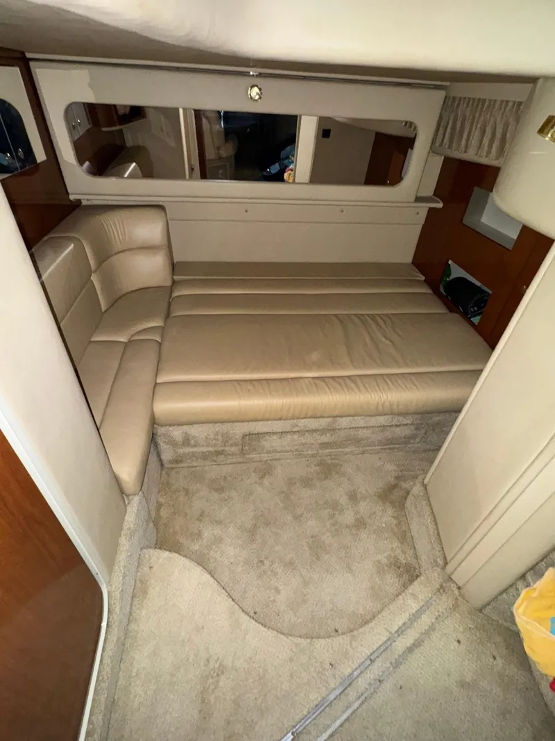Slide: The Image of 2002 Sea Ray 410 Sundancer cabin interior with beige seating and carpet. - 11