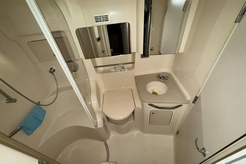 Slide: The Image of Bathroom interior of 2002 Sea Ray 410 Sundancer yacht, featuring shower and sink. - 12