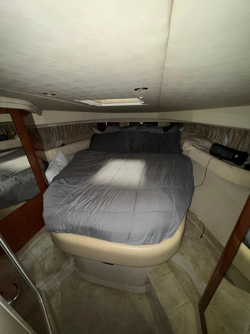 Slide: The Image of Interior cabin of 2002 Sea Ray 410 Sundancer with cozy bed and modern design. - 2