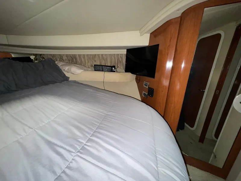 Slide: The Image of Interior cabin of 2002 Sea Ray 410 Sundancer with bed and TV. - 3