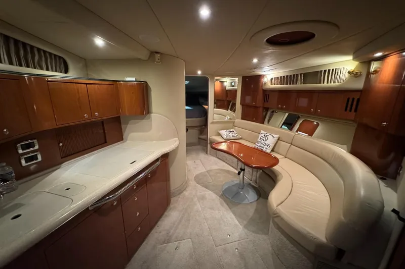 Slide: The Image of Luxurious interior of 2002 Sea Ray 410 Sundancer yacht with elegant seating and cabinetry. - 5