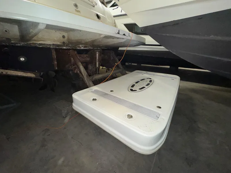 Slide: The Image of 2002 Sea Ray 410 Sundancer boat underside, showing propeller and swim platform in storage. - 6