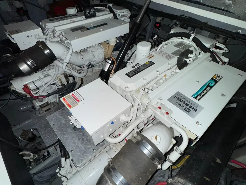 Slide: The Image of Engine room of a 2002 Sea Ray 410 Sundancer boat, showcasing dual engines. - 8
